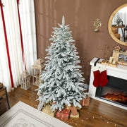 6ft snow flocked tree by a fireplace with stockings and wrapped presents