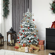 5ft snow flocked tree decorated with red and gold baubles beside a black chest of drawers