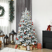 6ft snow flocked tree decorated with red and gold baubles in a living room with a wreath