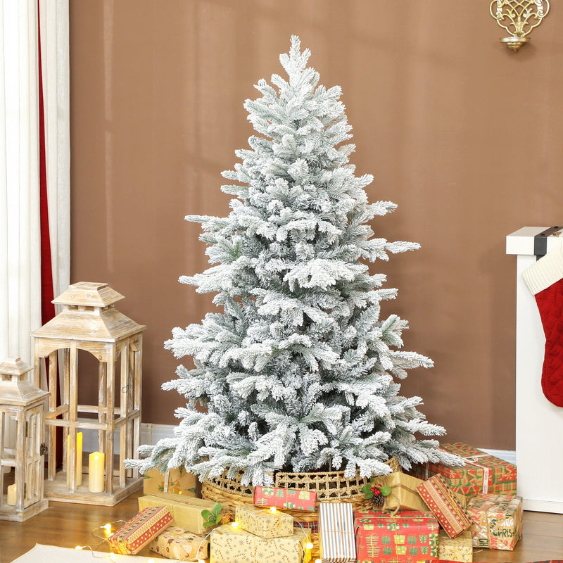 5ft snow flocked tree surrounded by wrapped presents in a lit living room