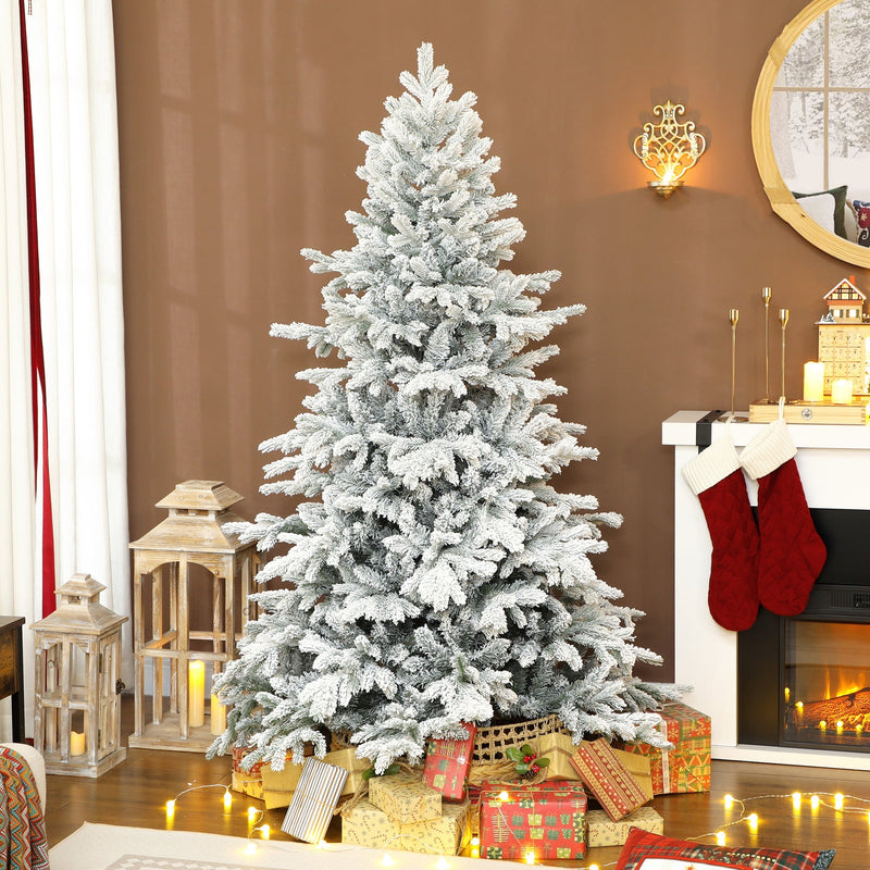 6ft snow flocked tree by a fireplace with stockings and wrapped presents