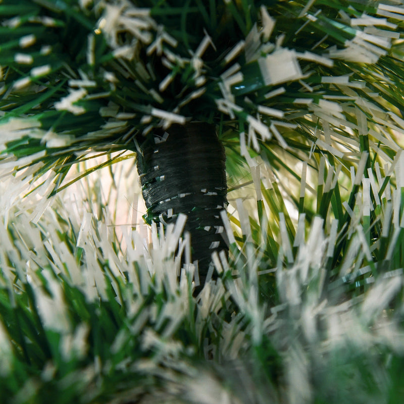 Close-up of the tree trunk joint surrounded by snow-flocked tips