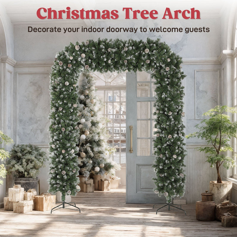Christmas tree arch decorating an indoor doorway with a frosted tree beyond