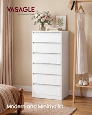 White tall chest of drawers in a bedroom beside a clothes rail and bed
