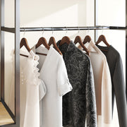 Row of dark walnut wood hangers on a clothes rail holding coats and shirts