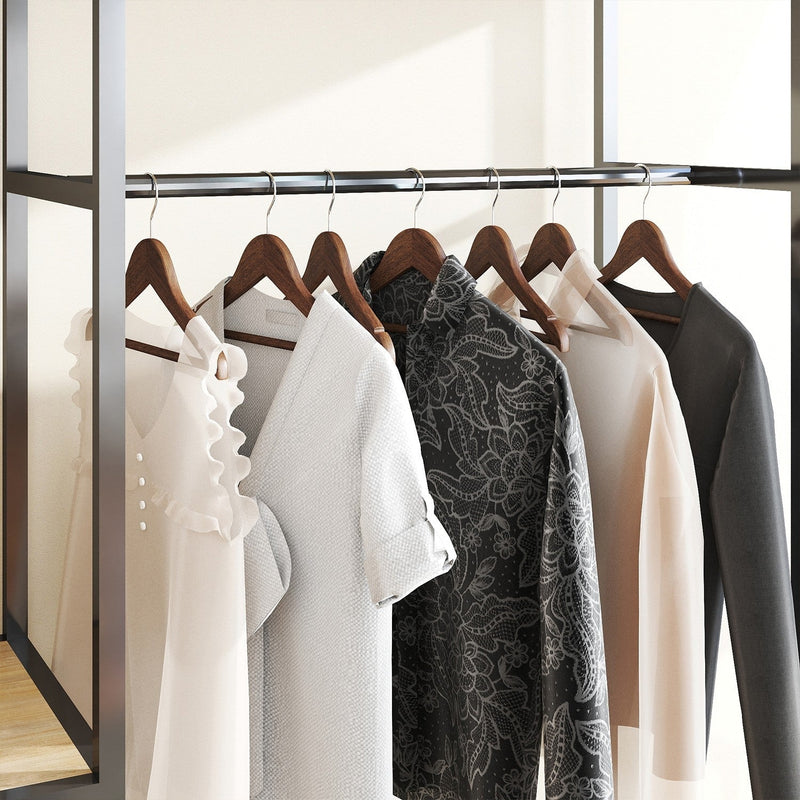 Row of dark walnut wood hangers on a clothes rail holding coats and shirts