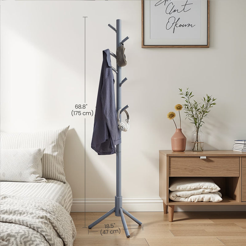 The grey coat rack next to a bed, labelled 175 cm tall with a 47 cm wide tripod base