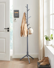 Coat rack shown fully hung with coats, bags and scarves in a hallway