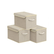 Three Songmics sand beige fabric storage boxes with lids stacked together
