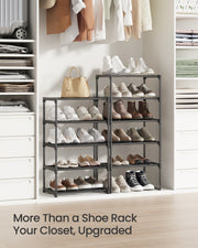 Two black shoe racks styled in a walk-in closet full of shoes