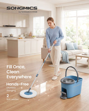 Woman mopping a bright living room floor with the grey and blue spin mop and bucket
