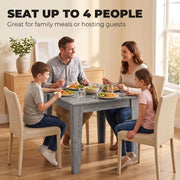 Family of four eating together around the grey dining table