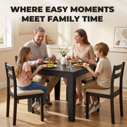 Family sitting around the Black Wood Effect dining table sharing a meal