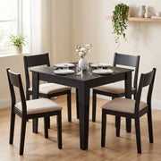 Black Wood Effect dining table with four matching chairs in a dining room