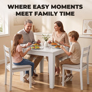 Family sitting around the white dining table sharing a meal