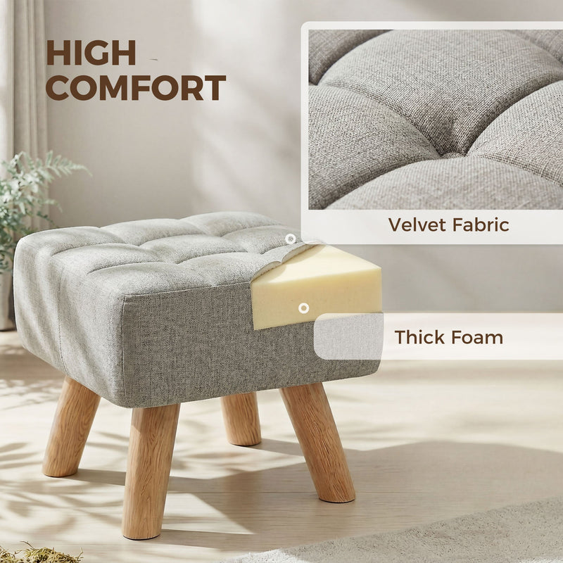 Close-up of the tufted fabric top and foam padding layer inside the footstool