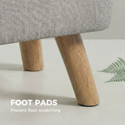Footstool placed beside an armchair and houseplant in a living room corner