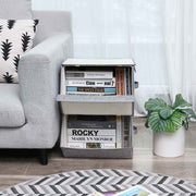 Grey storage boxes beside a sofa holding books and records in a living room