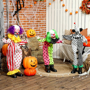 Three Halloween animated clown figures displayed together on a decorated porch with pumpkins