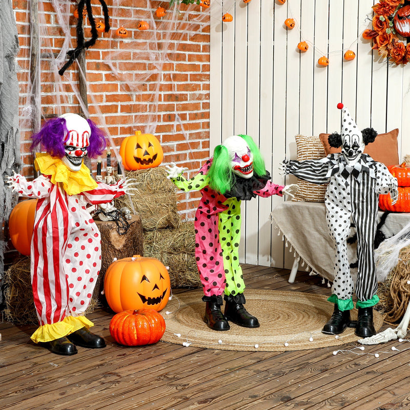 Three Halloween animated clown figures displayed together on a decorated porch with pumpkins