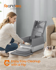 Woman scooping litter from the stainless steel cat litter box with the flip lid open, scoop and litter mat included