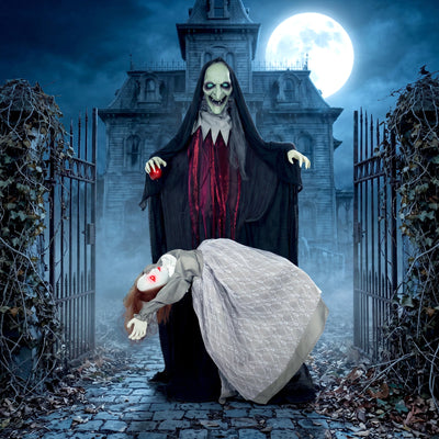 Witch and floating ghost decoration displayed at a haunted house gate at night