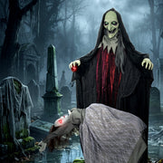 Witch and floating ghost decoration staged in a foggy graveyard scene