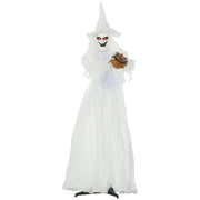 Standing white Halloween witch in a long gown holding a small carved pumpkin