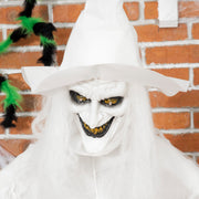Close-up of the witch's grinning face under her white pointed hat