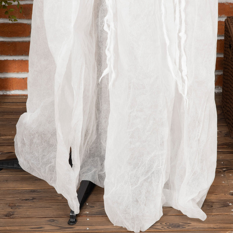 Lower half of the witch's white gown showing her black base stand on decking