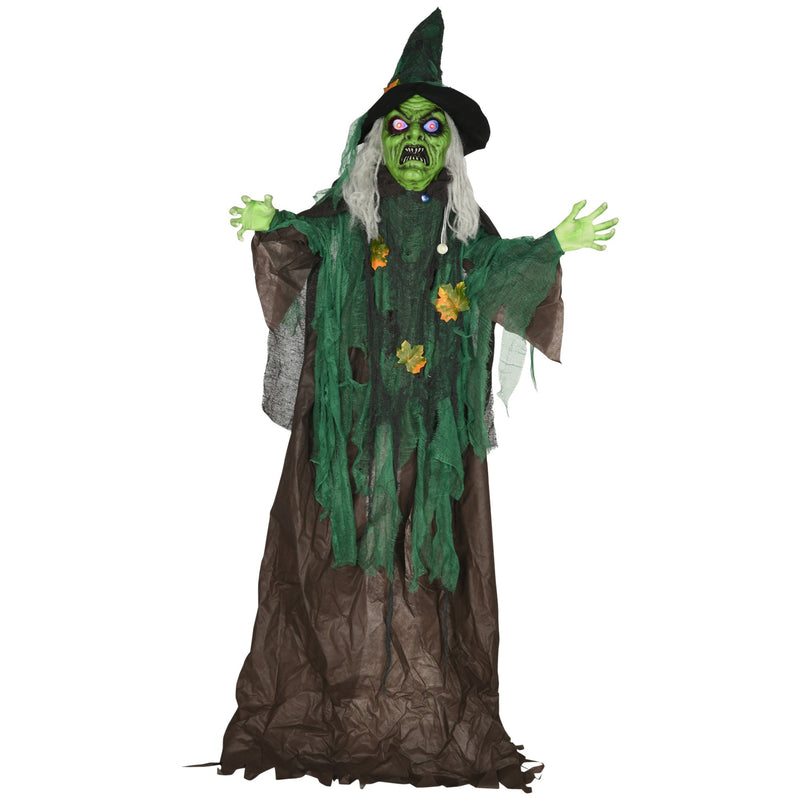 Standing Halloween witch prop with green skin and a tattered green robe on a white background