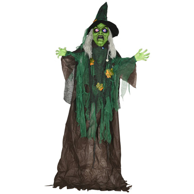 Standing Halloween witch prop with green skin and a tattered green robe on a white background