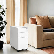 White 3-drawer steel file cabinet on wheels beside a sofa in a living room