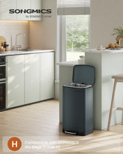 Grey Songmics pedal bin with lid open in a modern kitchen, compatible with Code H bin bags