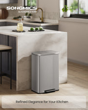 Songmics pedal bin styled in a modern kitchen next to a marble island