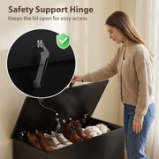 Close-up of the safety support hinge on the black storage bench with shoes stored inside