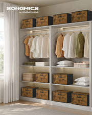 Rustic brown Songmics storage boxes styled across wardrobe shelves next to hanging clothes