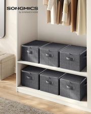 Six slate grey Songmics storage boxes with zipped lids arranged on wardrobe shelves