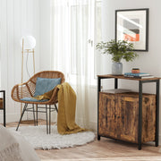 Rustic brown cabinet next to a rattan chair with a yellow throw over the arm