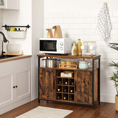 The cabinet in a kitchen holding a microwave, pans and bottles in the wine rack