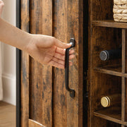 Hand pulling the black bar handle to open one of the cupboard doors