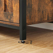 Close-up of a black steel leg with its 360 degree adjustable foot on a wood floor