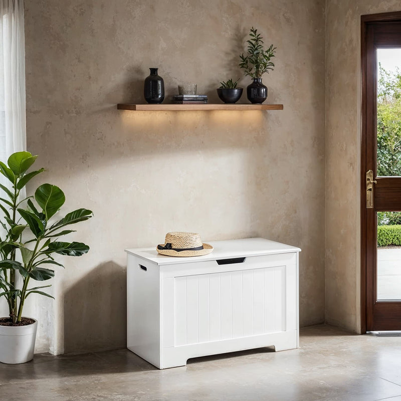 White storage chest bench beside a doorway with a houseplant and shelf alongside
