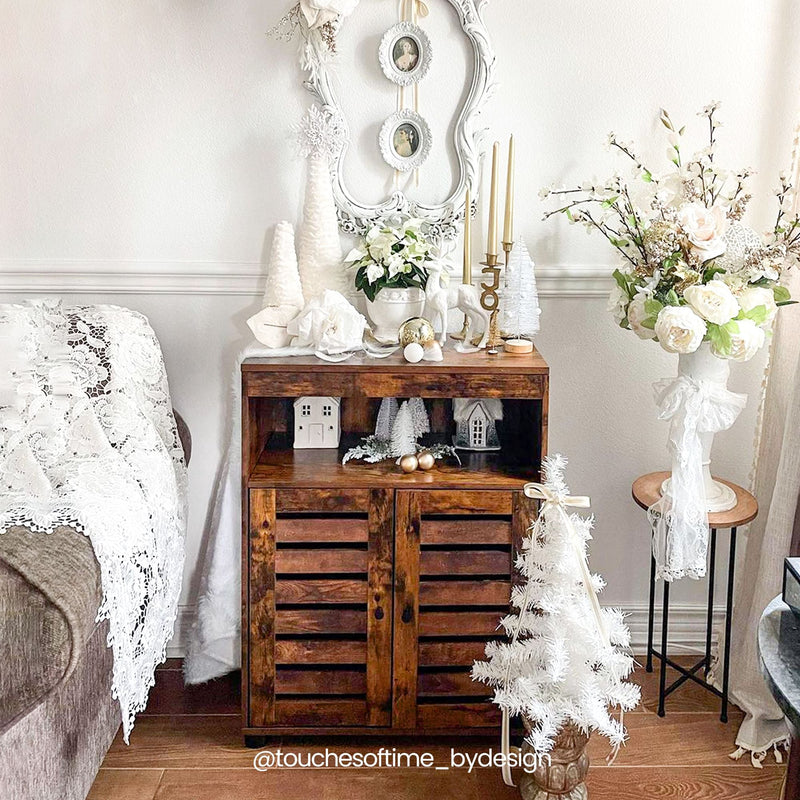 Cupboard styled in a bedroom with candles, flowers and white decorations