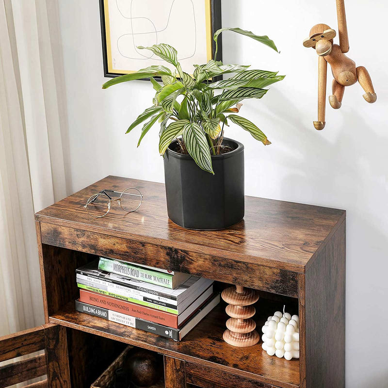 Close-up of the cupboard top with a plant, and books stored on the shelf below