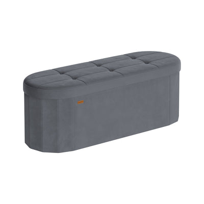 Slate grey velvet SONGMICS storage ottoman with tufted racetrack-shaped lid on a white studio background.