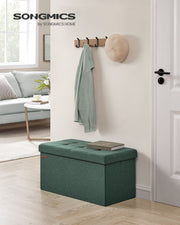 Retro green ottoman bench used as a hallway seat below a wall coat rack