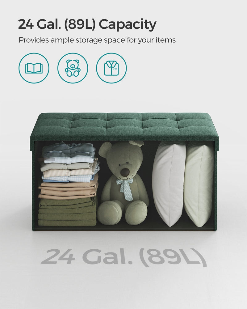 Ottoman bench open at the front showing folded clothes, a teddy and pillows in the 89 L interior