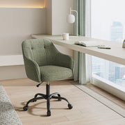Green office chair at a long white desk beside a floor-to-ceiling window