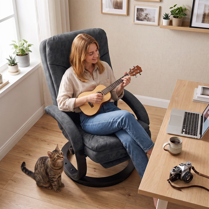 Musician strumming a ukulele in the swivel chair with a cat and camera nearby